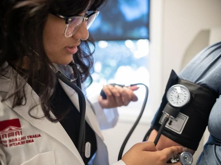 A student takes a patients blood pressure during their rotation