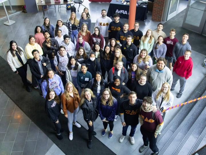 A group of students stand together in the Student Center